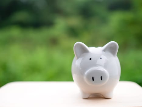 white piggy bank on a pink background. Savings and investment concepts.