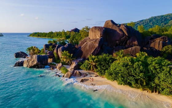 Anse Source d'Argent, La Digue Seychelles, a young couple of men and women on a tropical beach during a luxury vacation in Seychelles islands
