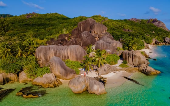 Anse Source d'Argent, La Digue Seychelles, a young couple of men and women on a tropical beach during a luxury vacation at the Seychelles.