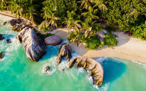 Anse Source d'Argent, La Digue Seychelles, a couple of men and women on a tropical beach during a luxury vacation in Seychelles. Tropical beach Anse Source d'Argent, La Digue Seychelles