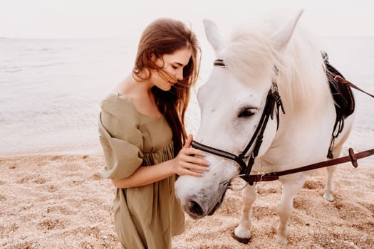 A white horse and a woman in a dress stand on a beach, with the sky and sea creating a picturesque backdrop for the scene