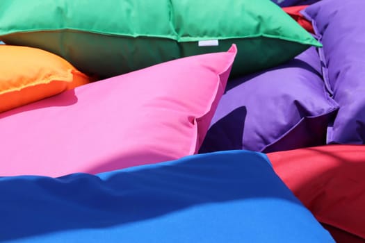 Scattered cushions in various colors.