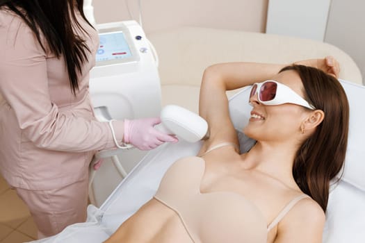 Elos epilation hair removal procedure on a womans body. Beautician doing laser rejuvenation in a beauty salon. Removing unwanted body hair. Hardware ipl cosmetology. Laser epilation.