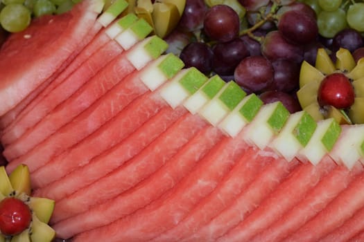 red fresh watermelon cut into equal slices for summer dessert. High quality photo