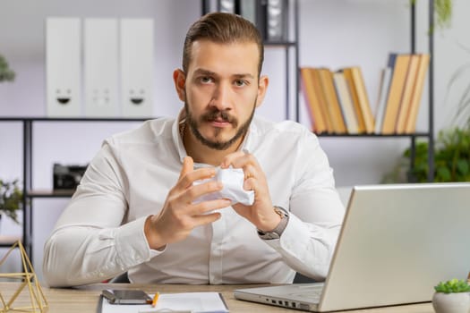 Angry boss business man making webcam online video call talking colleague conversation analyzing financial report mistake problem, crumples paper throws it away at office. Conflict Quarrel Negotiation