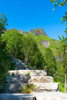 Stone stairs to the top of Reinebringen. Touristic path to the Reine viewpoint, Reine, Lofoten, Norway.