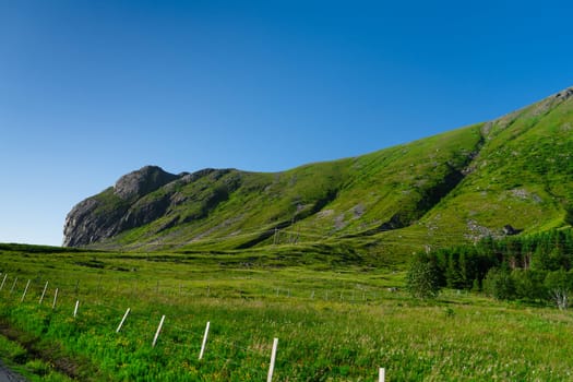 Lofoten Summer Landscape .Lofoten is an archipelago in the county of Nordland, Norway. Is known for a distinctive scenery with dramatic mountains and peaks, sea and ocean.