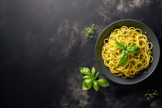 Spaghetti with cheese in a black plate with space to insert text. View from above. High quality photo