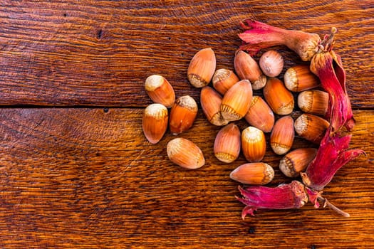 Fresh ripe red hazelnuts on wooden table