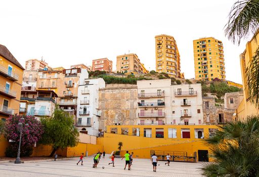 Porto Empedocle, Italy - July 22: Children play soccer in the Porto Empedocle square on July 22, 2021