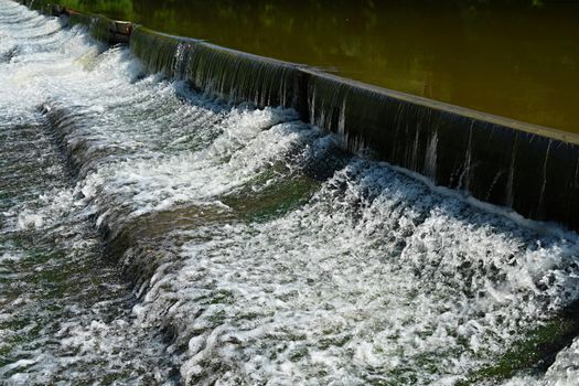 Sluice on the river. Beautiful outdoor nature with running water.