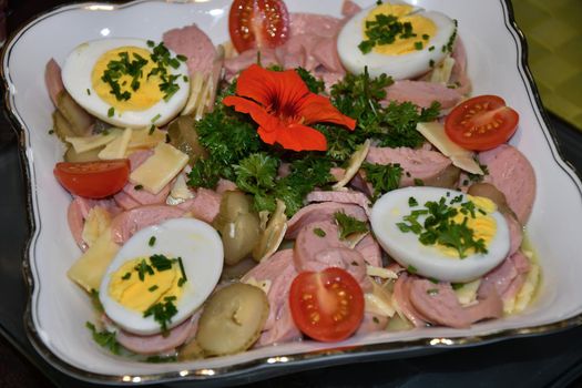 German salad of sausage with eggs