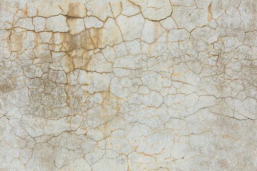 cracked white concrete wall under direct sun light full frame background and seamless texture.