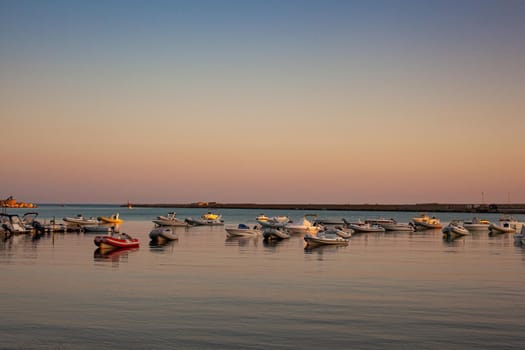 View of a lot of boats in the Porto Empedocle sea at sunset