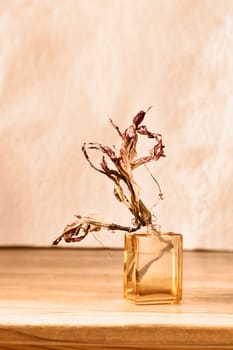 Red dried flowers in glass vase on wooden table , romantic activity , moment dedicated to memories