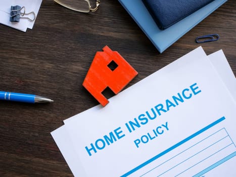 Home insurance policy and model of home.