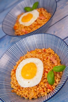 RECIPE FOR BLE WITH BACON, TOMATO AND SHALLOTS, SERVED WITH FRIED EGG. High quality photo