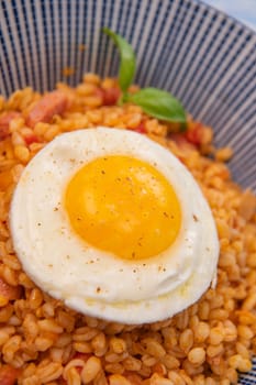 RECIPE FOR BLE WITH BACON, TOMATO AND SHALLOTS, SERVED WITH FRIED EGG. High quality photo