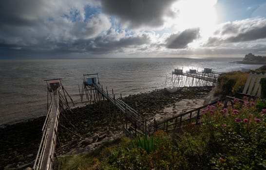 Traditional fisherman's wooden hut at the bottom of the limestone cliff in the estuary of Gironde, Talmont-sur-Gironde, France. High quality photo