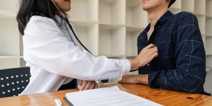 Close up of Doctor using stethoscope to exam heart and lungs of patient male.