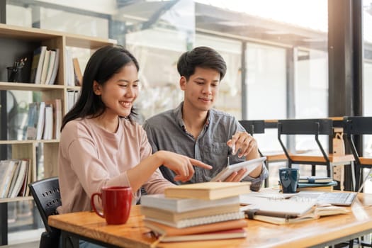 Male and female students reading a book. library research, reading and students with a book, learning knowledge at college. Scholarship, smile at university for education.