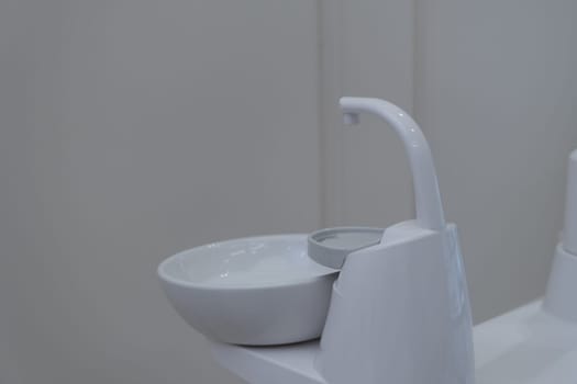 Dental cuspidor used for patients when they have to rinse their mouth. Dental cuspidor. Ceramic bowl