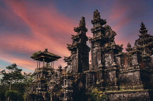 Magnific landscape view of besakih temple with fiery beautiful sky. Sacred balinese temple with traditional architecture