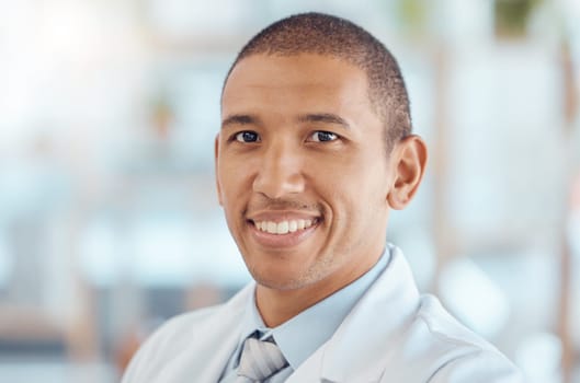 Doctor, portrait and man with smile in office, healthcare and confidence at hospital with trust, support and help. Face of happy medical professional, expert in medicine and career in health care