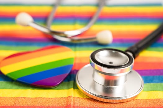 Black stethoscope on rainbow flag with heart, symbol of LGBT pride month celebrate annual in June social, symbol of gay, lesbian, bisexual, transgender, human rights and peace.