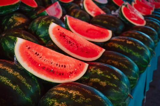 Fresh watermelons sale in the traditional farm Turkish market, a counter filled with fresh fruits