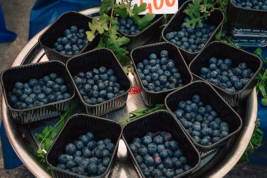 Blueberry sale in the traditional farm Turkish market, a counter filled with fresh fruits