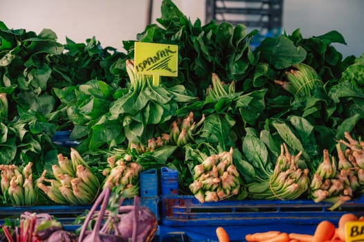 Fresh spinach sale in the traditional farm Turkish market, a counter filled with fresh fruits