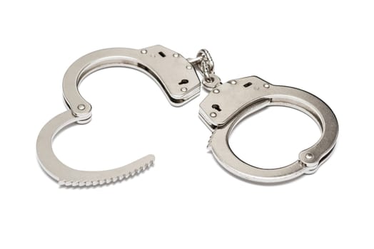 Pair of steel handcuffs isolated on white background. Silver metal handcuffs on white.