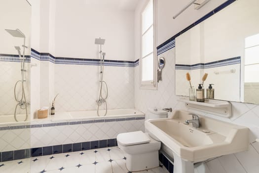 In a beautiful bathroom, modern fixtures and tasteful decor create an inviting atmosphere. The room features a bathtub, shower, sink, and stylish interior design.