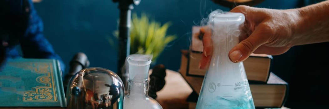 Schoolgirl perform chemical experiments. Flasks with solutions and chemical formulas on the blackboard in the school classroom. Back to school. School and preschool education.