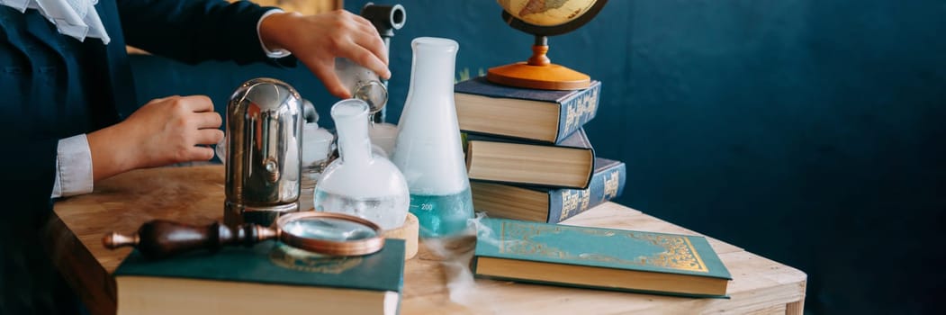 Schoolgirl perform chemical experiments. Flasks with solutions and chemical formulas on the blackboard in the school classroom. Back to school. School and preschool education.