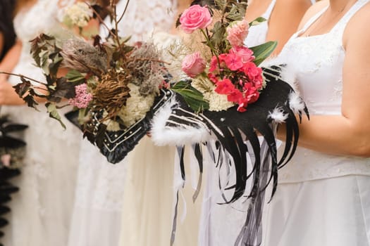 The bride holds her wedding bouquet in her hands.