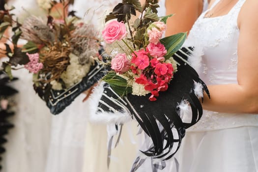 The bride holds her wedding bouquet in her hands.