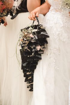 The bride holds her wedding bouquet in her hands.