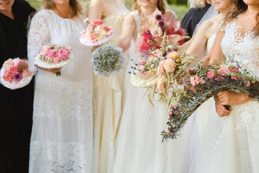 Many brides hold their wedding bouquet in their hands.