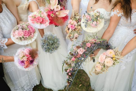 Many brides hold their wedding bouquet in their hands.