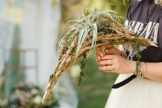 The bride holds her wedding bouquet in her hands.