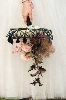 The bride holds her wedding bouquet in her hands.