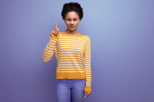 portrait of positive smart latin young woman with ponytail made of afro hair on background with copy space.