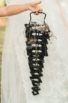 The bride holds her wedding bouquet in her hands.