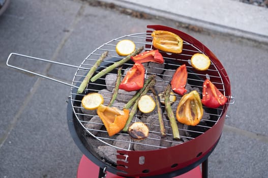 barbecue of colorful raw vegetables on a grill on blue shabby boards, vegetarian food, delicious vegan food, summer picnics. High quality photo