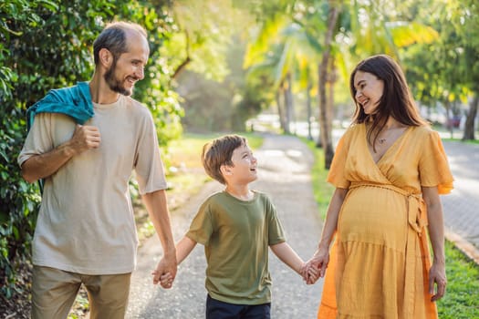 A loving family enjoying a leisurely walk in the park - a radiant pregnant woman after 40, embraced by her husband, and accompanied by their adult teenage son, savoring precious moments together amidst nature's beauty. Pregnancy after 40 concept.