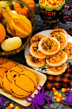 Sugar cookies with orange icing and spkinkles.