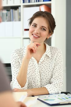 Portrait of smiling woman at work table with documents. Business consulting concept