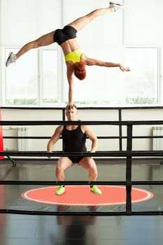 Image of strong man doing acrobatic rack with his partner